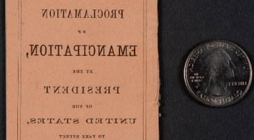 Miniature Copy of the Proclamation of Emancipation next to a Quarter